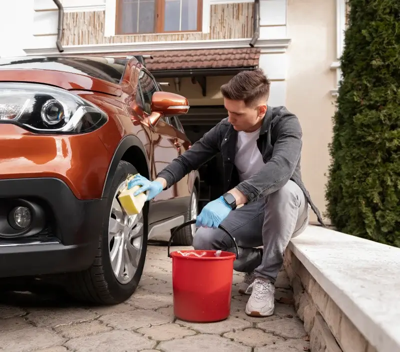 Lavage auto à domicile Saint-Didier-de-Formans : professionnel intervenant sur un véhicule